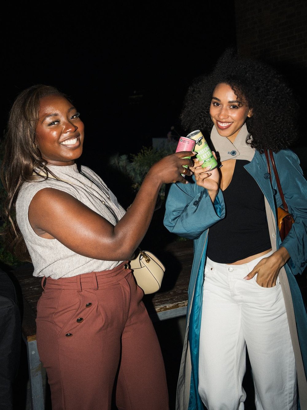 Two women laughing and raising a toast at a WCAN evening